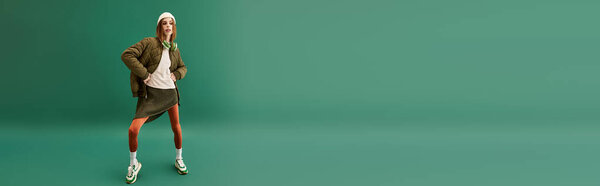 A young woman displays resilience against anorexia in a simple, green backdrop.