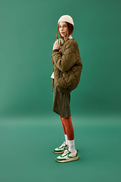 A young woman with anorexia stands in a studio, showcasing her struggle against an eating disorder.