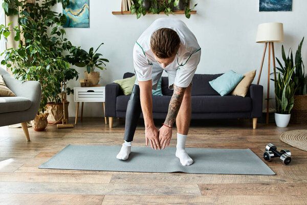 Focused man bends down in a bright living room, demonstrating yoga skills and resilience.