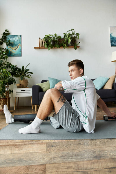 Handsome young man practices stretching in a modern living room filled with greenery.