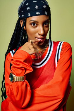 A young woman showcases her unique style with bold colors and accessories while striking a pose. clipart