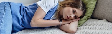 A teenage girl relaxes in her stylish room, reflecting on her day while lying on the bed, banner clipart