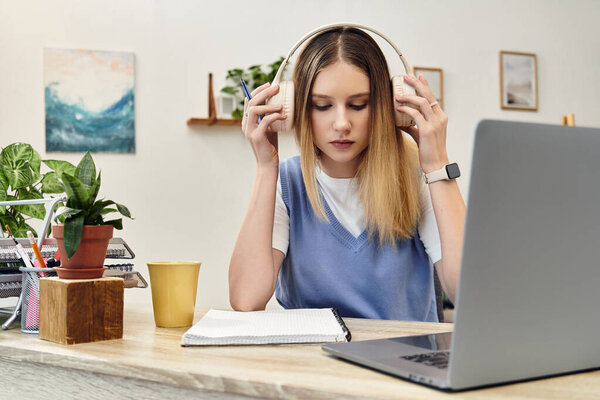 Engaged in her studies, a young girl enjoys the comfort of her modern room.