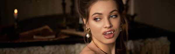 A stunning young woman with captivating features exudes a mysterious vampire allure.