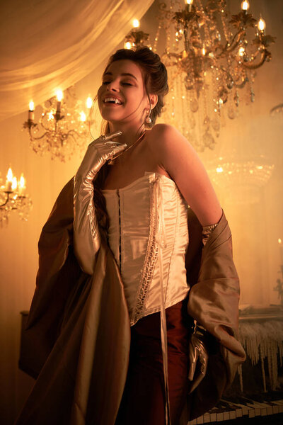 A stunning young woman in elegant attire enchants with her mystical aura in a grand ballroom.