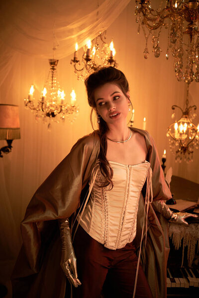 A beautiful young woman in a corset and gloves embodies the rooms mystical ambiance.