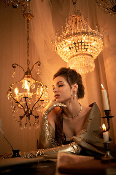 A young woman with an enchanting gaze contemplates in her mystical, candlelit lair.