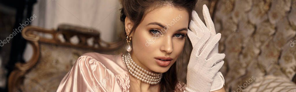 A young woman in vintage clothes exudes a magical charm in a whimsical setting.