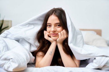 A young woman wrapped in soft blankets smiles warmly, embracing the comfort of her morning routine. clipart