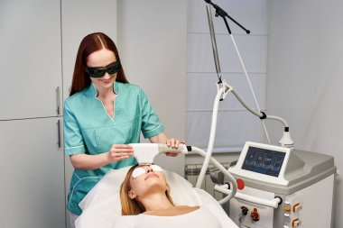 A skilled dermatologist performs a skin treatment on a young woman to improve her complexion. clipart