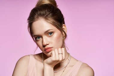 Çekici genç bir kadın, kendine güvenen, kendinden emin bir şekilde poz verirken şık görünümünü sergiliyor..