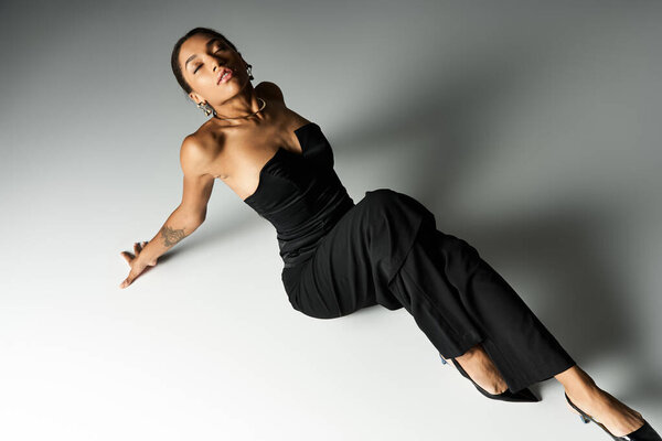 Elegant young woman showcasing chic attire style in a modern setting.