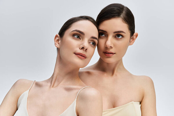 Delicate twins showcase their stunning features against a minimalist background, radiating charm.
