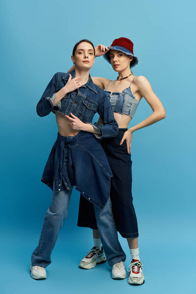 Две красивые сестры демонстрируют уникальные джинсовые наряды, привлекая внимание поразительными позами.