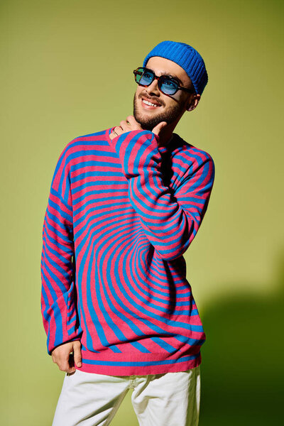 A stylish young man showcases his fashion sense in a playful outfit and cool sunglasses.