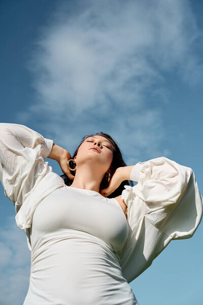 A confident female stands outdoors, embracing the warm sun and enjoying natures beauty.