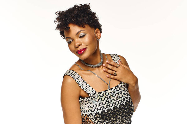 Radiant woman embraces her beauty with a charming smile and stylish attire, exuding confidence.