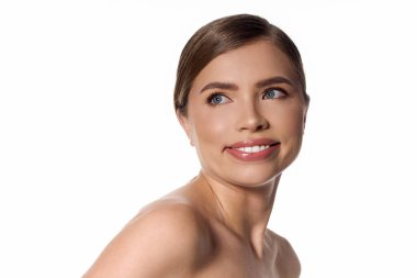 A young woman radiates elegance and charm with a chic smile, enhancing her natural beauty.