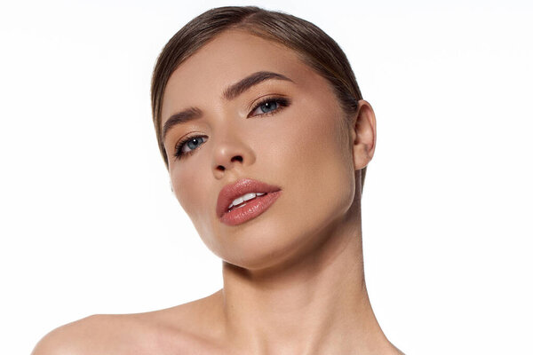 Young woman showcases beauty and style, exuding elegance with a striking pose and flawless makeup.