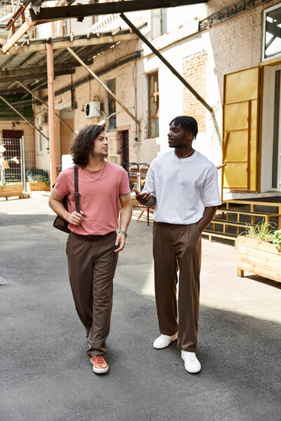Loving couple strolls together in a charming cafe courtyard, sharing laughter and conversation.