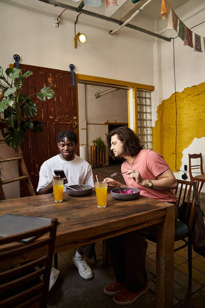 In a cozy cafe, a couple enjoys drinks, laughter, and conversation on their date.