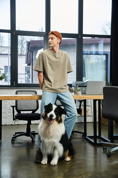 Dedicated young professional enjoys a moment with his dog in a bright office setting.