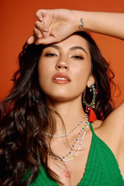 Genç bir kadın canlı bir yaz görüntüsü sergiliyor. Renkli mücevherler ve parlak bir gülümsemeyle..