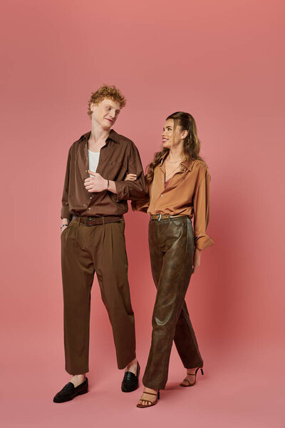 Amorous couple shares a joyful connection while dressed in trendy attire, radiating love and style.