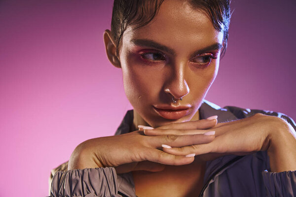 A young woman shows off her trendy style against a holographic backdrop.