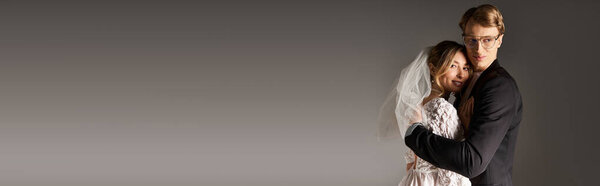 A young couple embraces warmly, celebrating their love during a beautiful spring wedding ceremony, banner