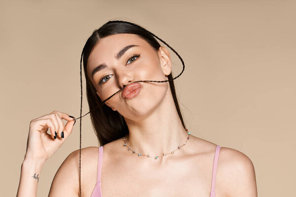 Young woman with a perfect sun tan playfully poses while embracing summer energy.