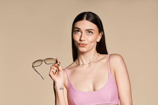 A young woman has fun in summer with stylish sunglasses and sun-kissed skin.