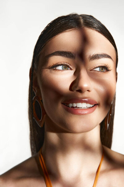 Sun-kissed young woman radiates joy while enjoying warm sunlight with summer flair.