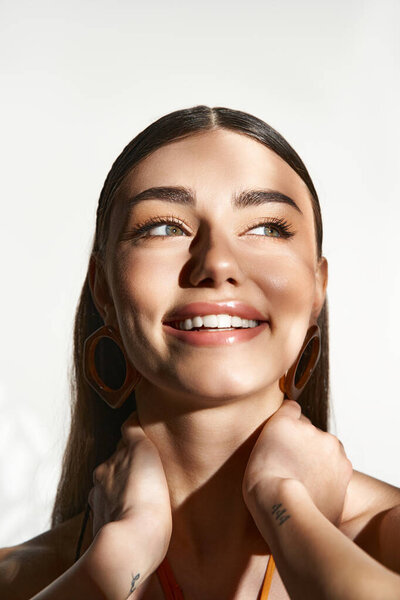 A young woman enjoys the warmth of summer while embracing her sun-kissed skin.