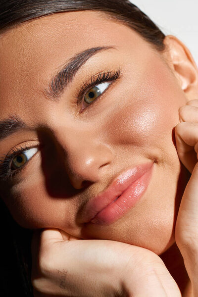 Pretty young woman enjoys summer vibes with a sun-kissed tan while relaxing peacefully.