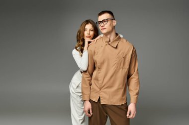 Güzel gelin ve damat, zarif giysiler içinde, neşe saçan bir aşk ve bağ anlarını paylaşıyor..