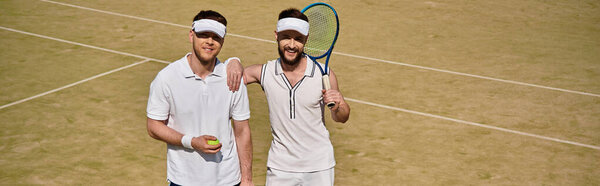 Gay couple share a joyful moment on the tennis court playing together during summer, banner