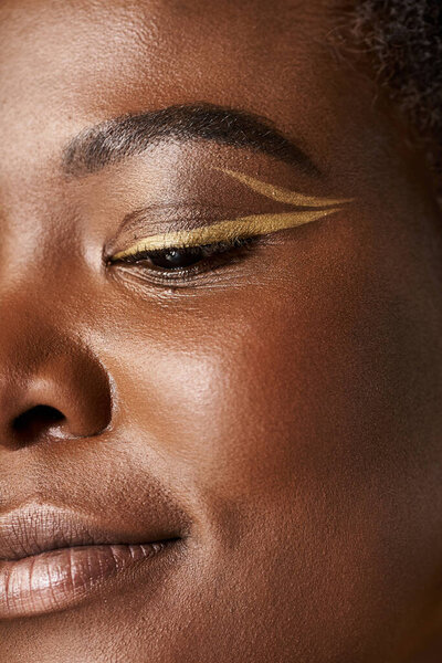 Young woman with flawless skin poses in studio, emphasizing beauty and creativity.