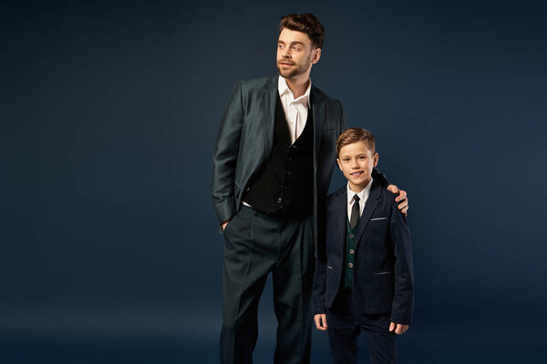 A father and son share a joyful moment, dressed smartly for Fathers Day celebrations in 2025.