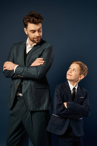 A father and son share a heartfelt moment, dressed smartly for a special celebration in 2025.