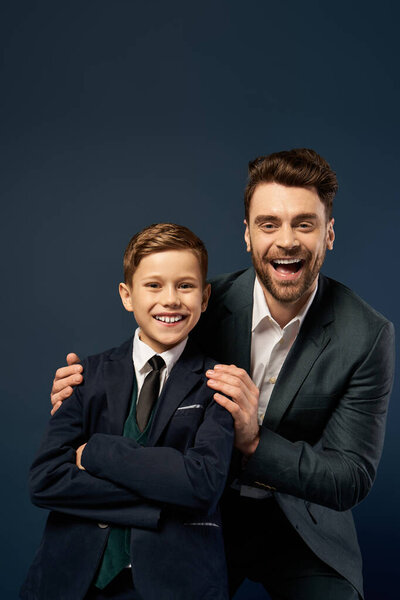 A cheerful father and son duo pose together, showcasing their bond and delight on Fathers Day.