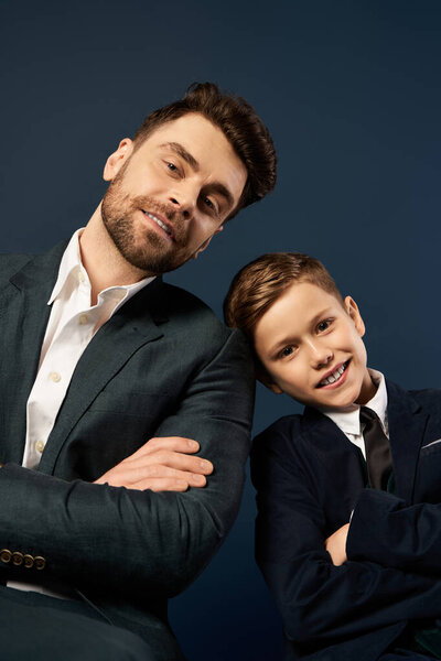 A father and son pose proudly together, showcasing their close bond on Fathers Day celebration.