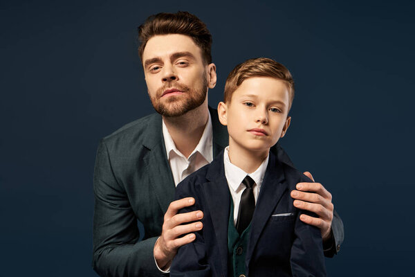 Two stylish individuals pose together in formal attire, showcasing their bond on Fathers Day.