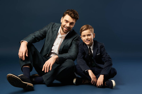 A father and son bond, both dressed elegantly, capturing festive moments of togetherness.