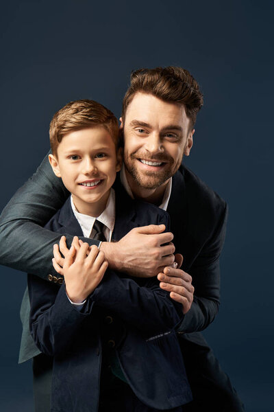A joyful father hugs his elegantly dressed son, sharing a special moment on Fathers Day.