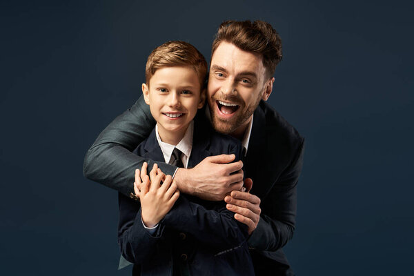 A father and son share a heartwarming moment of joy and celebration together.