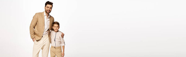 A father and son share smiles in a festive atmosphere, marking a special Fathers Day celebration.