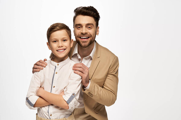 Father and son share a warm embrace and smile together in a moment of joy and togetherness.