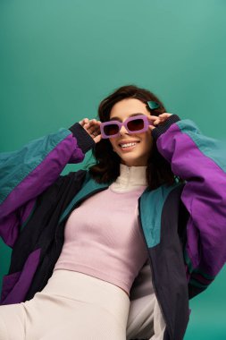 Genç kadın cesur moda anlayışını bir stüdyo ortamında sportif bir bakışla sergiliyor..