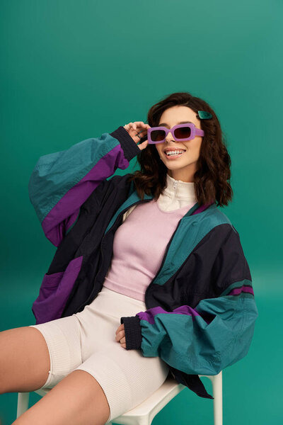 A young happy woman in trendy sportswear showcases her fashion sense with confidence.